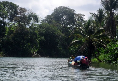 Kuna family going up the river for laundry